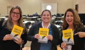 Margo, Ali, and Megan holding Mark Schaefer's Cumulative Advantage books